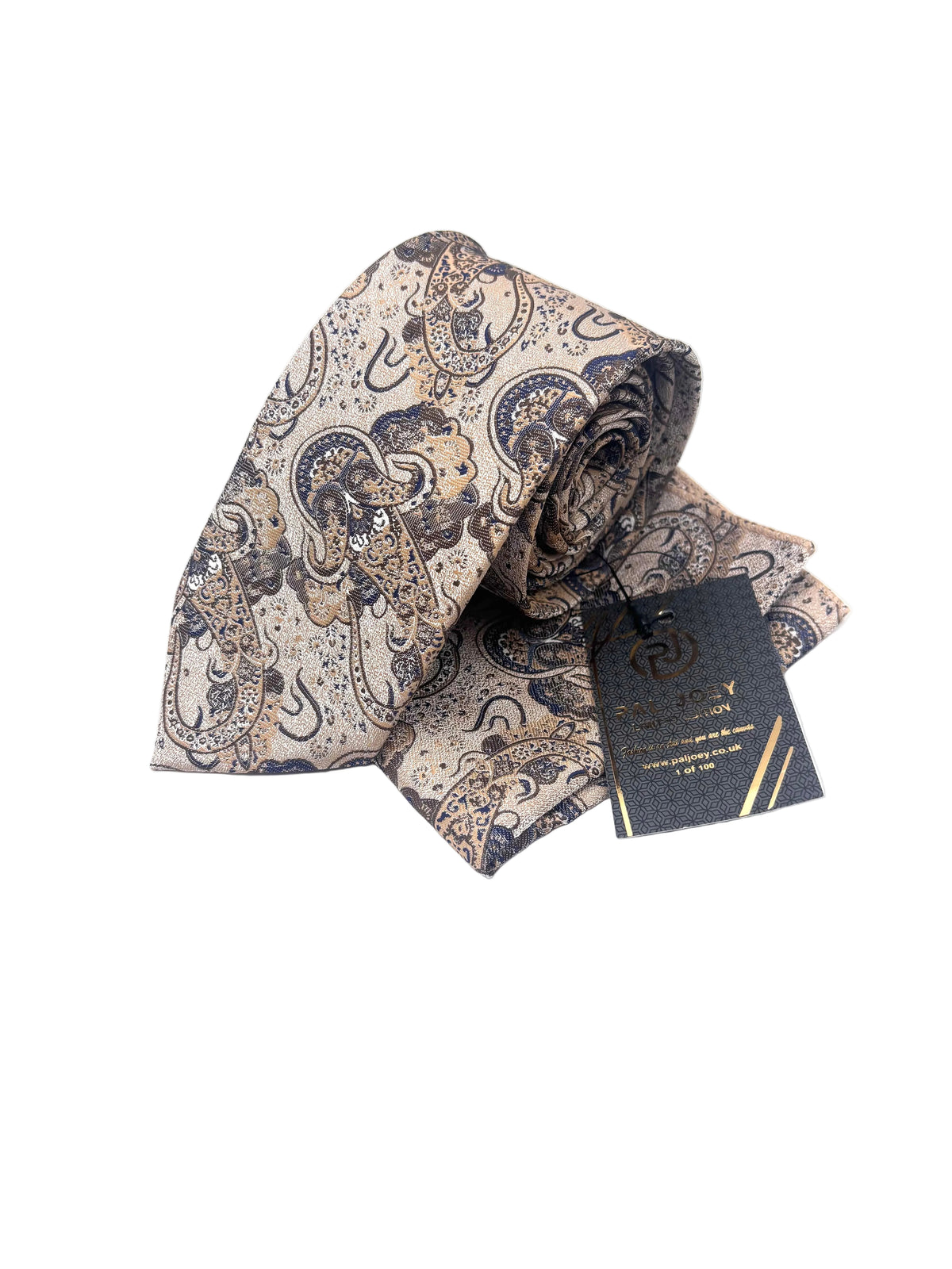 A rolled silk necktie with an intricate paisley pattern in beige, navy blue, and brown, displayed next to its black branded hangtag on a white background.