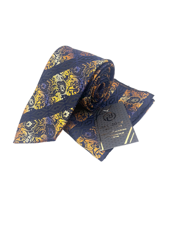 A rolled necktie with a navy blue base and an intricate golden-yellow and orange baroque pattern, shown with its branded black paper tag on a white background.